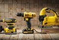 Construction carpentry tools electric corded jigsaw cordless drill and wood sander on wooden background Royalty Free Stock Photo