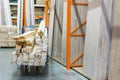 construction cart in the building store. Carts loaded with boards. shop of building materials. Racks with boards, wood and Royalty Free Stock Photo