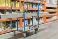 construction cart in the building store. Carts loaded with boards. shop of building materials. Racks with boards, wood and Royalty Free Stock Photo