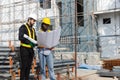 Construction civil engineer man and woman African American checking quality of work in construction site. Team of various Royalty Free Stock Photo