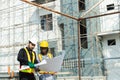 Construction civil engineer man and woman African American checking quality of work in construction site. Team of various Royalty Free Stock Photo