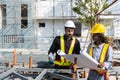 Construction civil engineer man and woman African American checking quality of work in construction site. Team of various Royalty Free Stock Photo