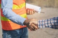 Construction company handshaking with material supplier