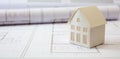 Construction concept. Residential building drawings and architectural house model on an office desk Royalty Free Stock Photo