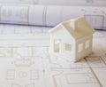 Construction concept. Residential building drawings and architectural house model on an office desk Royalty Free Stock Photo