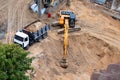 Construction of concrete foundation of new building. Construction machinery, excavator, top view Royalty Free Stock Photo