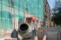 A construction concrete mixer stands near the building being repaired Royalty Free Stock Photo