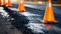 Construction cones designate fresh asphalt layer on roadway for safety and traffic management Royalty Free Stock Photo
