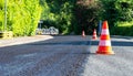 Construction cones marking part of road with a layer of fresh asphalt Royalty Free Stock Photo