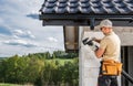 Construction Contractor Roof Worker Installing House Gutters Royalty Free Stock Photo