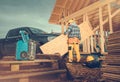 Construction Contractor Worker Moving Piece of Plywood