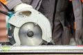 A construction contractor worker using a worm-driven hand-held circular saw to cut boards and plastic. Construction Royalty Free Stock Photo