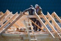 The construction of the cottage. Workers build the roof of the house. Country house Royalty Free Stock Photo