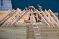 The construction of the cottage. Workers build the roof of house. Country house