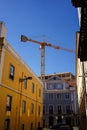 Construction crane above the colorful buildings in Lisbon, Portugal Royalty Free Stock Photo