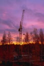 Construction crane on the background of the twilight sky at the construction site in autumn Royalty Free Stock Photo