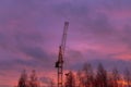 Construction crane on the background of the twilight sky at the construction site in autumn Royalty Free Stock Photo