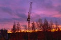 Construction crane on the background of the twilight sky at the construction site in autumn Royalty Free Stock Photo