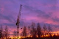 Construction crane on the background of the twilight sky at the construction site in autumn Royalty Free Stock Photo