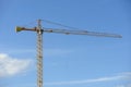 Construction crane on blue cloudy sky background