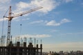 The construction crane and the building against the blue sky Royalty Free Stock Photo