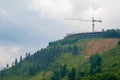 Construction crane building on hilltop
