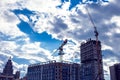 Construction crane on a building site against blue sky background. Development concept Royalty Free Stock Photo