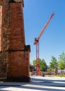 Construction crane on a building site. Construction next to the church. City infrastructure. Construction of a housing estate noah Royalty Free Stock Photo