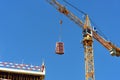 Construction crane with cargo on the background blue sky Royalty Free Stock Photo