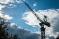 Construction crane elevating materials on building site Royalty Free Stock Photo