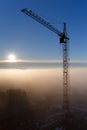 Construction crane in the fog at dawn Royalty Free Stock Photo