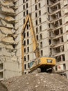 Construction crane in front of a half demolished apartment building