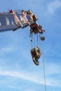 The construction crane with hook over cloud and blue sky background at construction s. Royalty Free Stock Photo