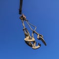 Construction crane hooks against the blue sky