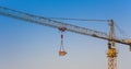 Construction crane lifting cargo with clear blue sky Royalty Free Stock Photo