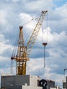 Construction crane for lifting and mounting panels, blocks in the construction of residential buildings, high-rises Royalty Free Stock Photo