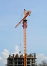 Construction crane lifts materials to the object under construction