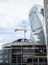 Construction crane and modern building under construction next to the skyscraper Royalty Free Stock Photo