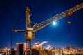 Construction crane at modern buildings construction site, night view Royalty Free Stock Photo