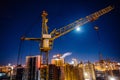 Construction crane at modern buildings construction site, night view Royalty Free Stock Photo