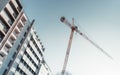 Construction crane near a house Royalty Free Stock Photo