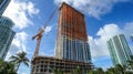 Construction crane next to a tall, partially built Royalty Free Stock Photo