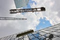 Construction crane and office buildings. Royalty Free Stock Photo