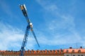 Construction crane over the attics Royalty Free Stock Photo