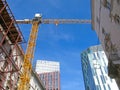 Construction crane on street between old buildings Royalty Free Stock Photo