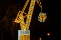 Construction crane symbol of Shipyard Holiday illuminated decorations in Gdansk Poland. Beautiful Christmas fair at