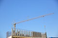 A construction crane is a tool for carrying large building materials to high heights.