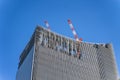 Construction crane on top of tower working to build high skycrapper office building in the development city, clear blue sky