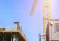 Construction crane tower on blue sky background. Crane and building working progress. Worker. Empty Space for text. Construction c Royalty Free Stock Photo