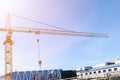 Construction crane tower on blue sky background. Crane and building working progress. Worker. Empty Space for text. Construction c Royalty Free Stock Photo